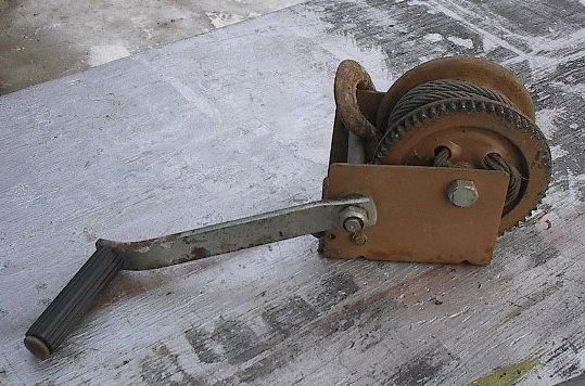 This is a vintage hand crank winch. Signed on the wrench Dutton 